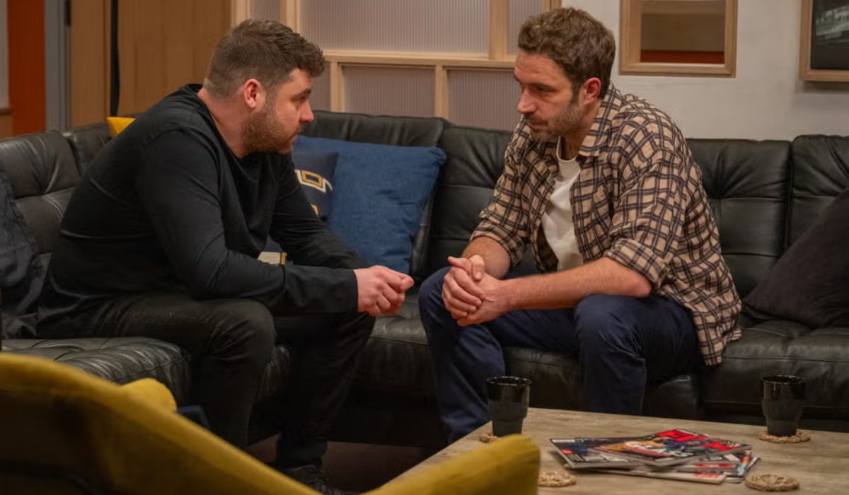 Emmerdale: John and Aaron sit on sofa and talk
